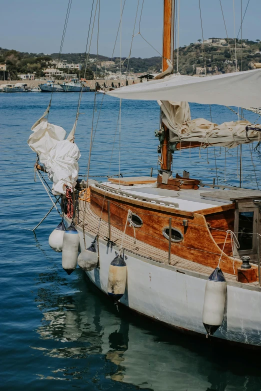 a sailboat sailing on the water close to shore