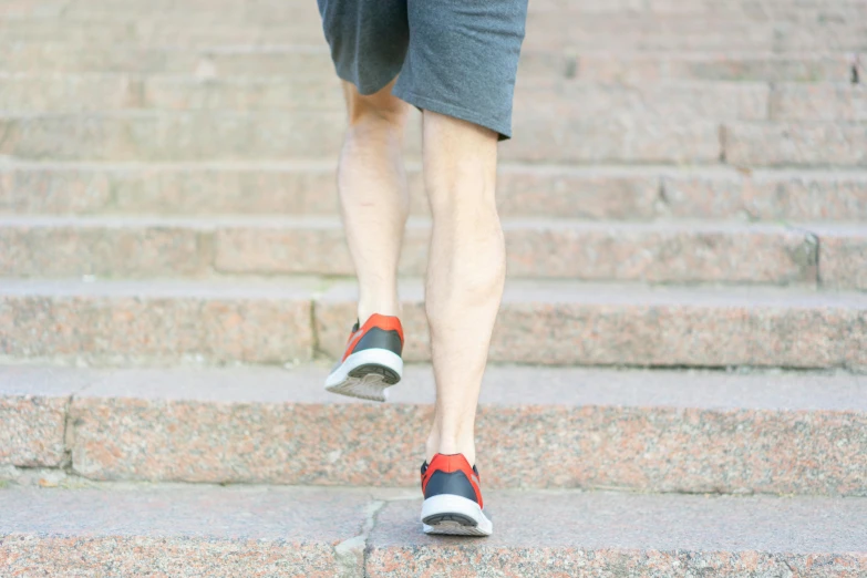 a person with shoes on walking down the stairs