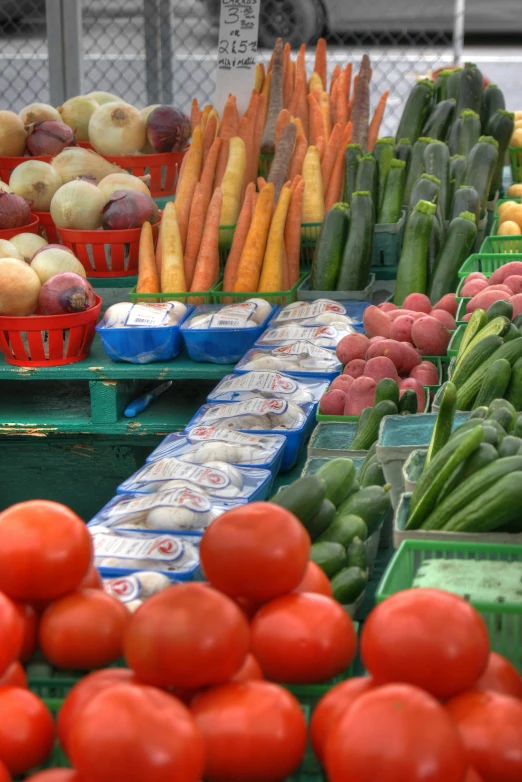 a display table filled with different kinds of fruits and vegetables