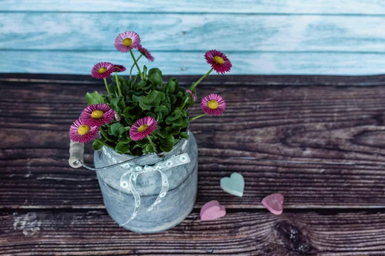 some pink flowers and a bunch of purple hearts