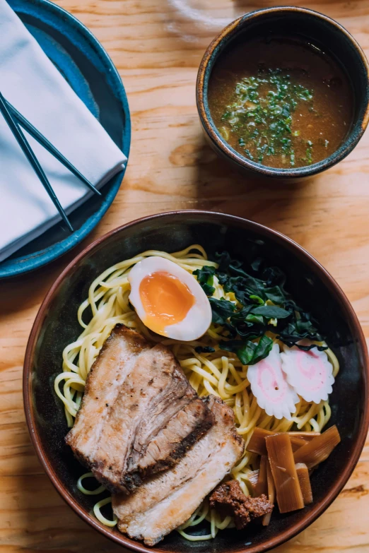 a bowl of noodles with a boiled egg on top