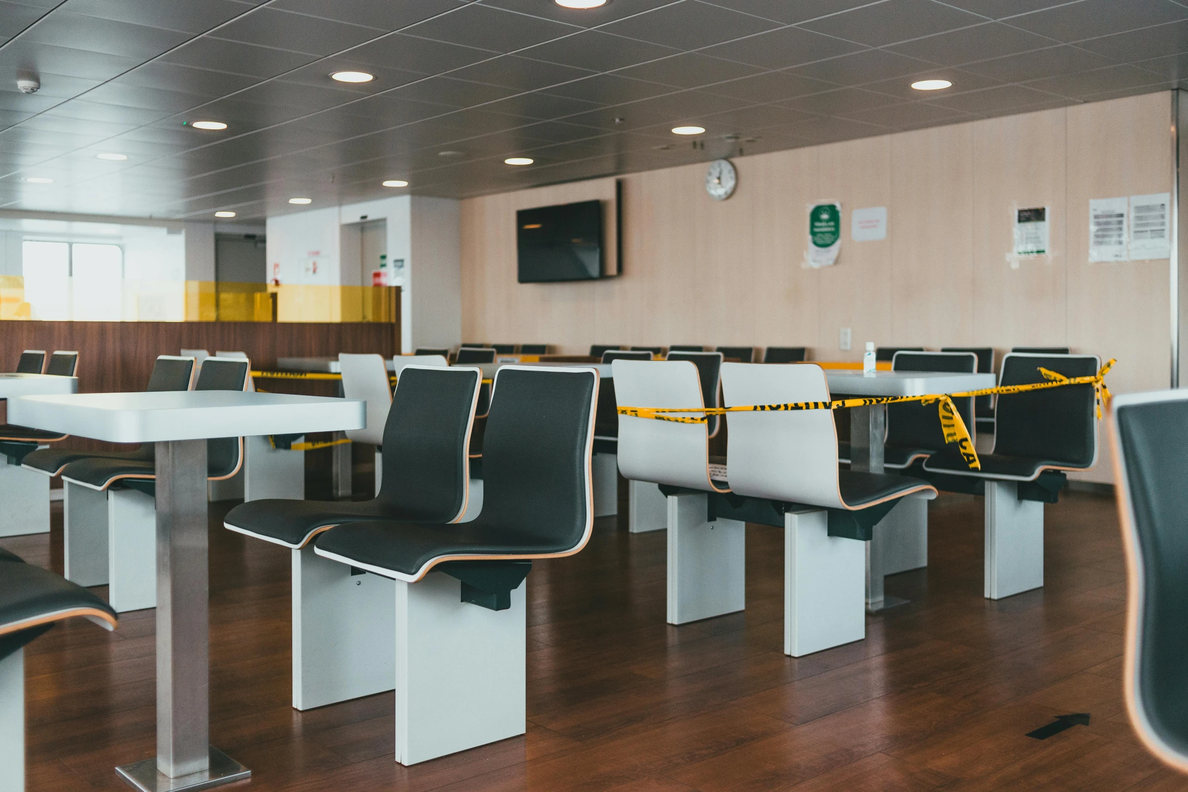 a long line of dining tables is next to chairs