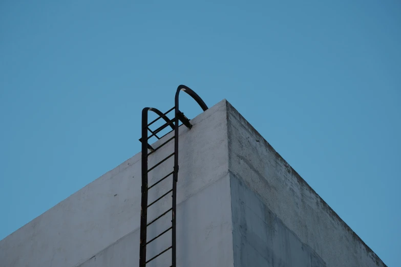 a ladder that is going up a wall