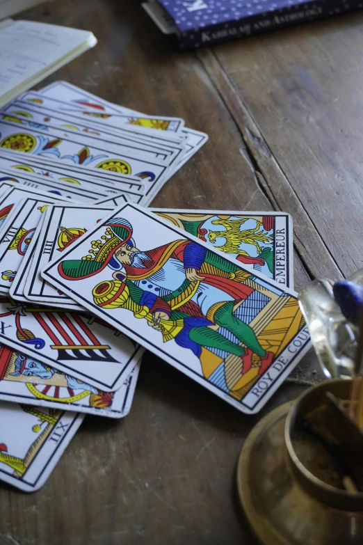 four playing cards and two drinks on a table