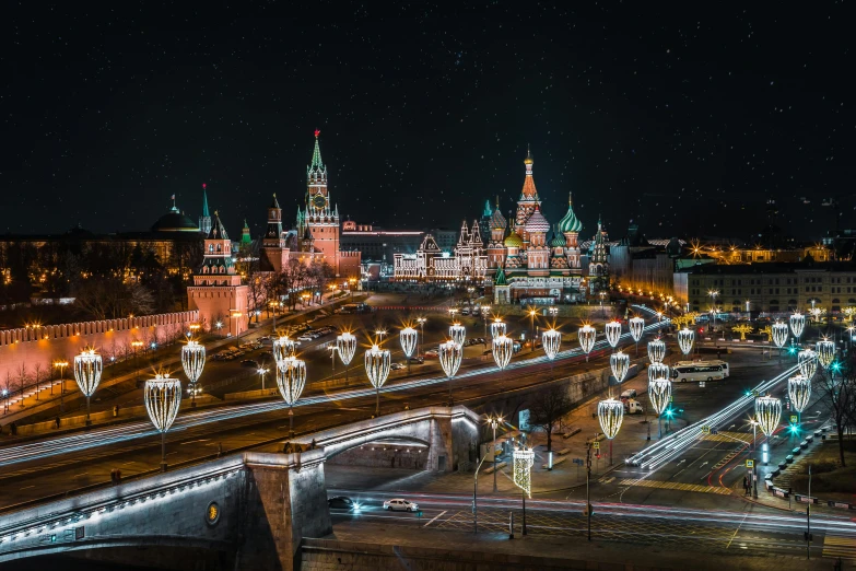 a lit up city street with the sky and lights of all shapes, sizes and colors