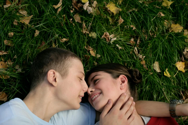 a young couple lying in the grass together
