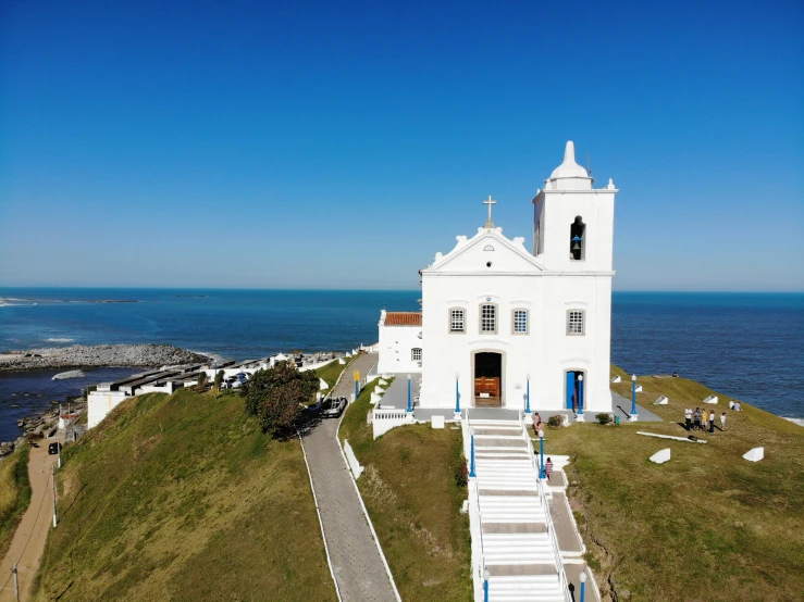 the white building is beside the blue water