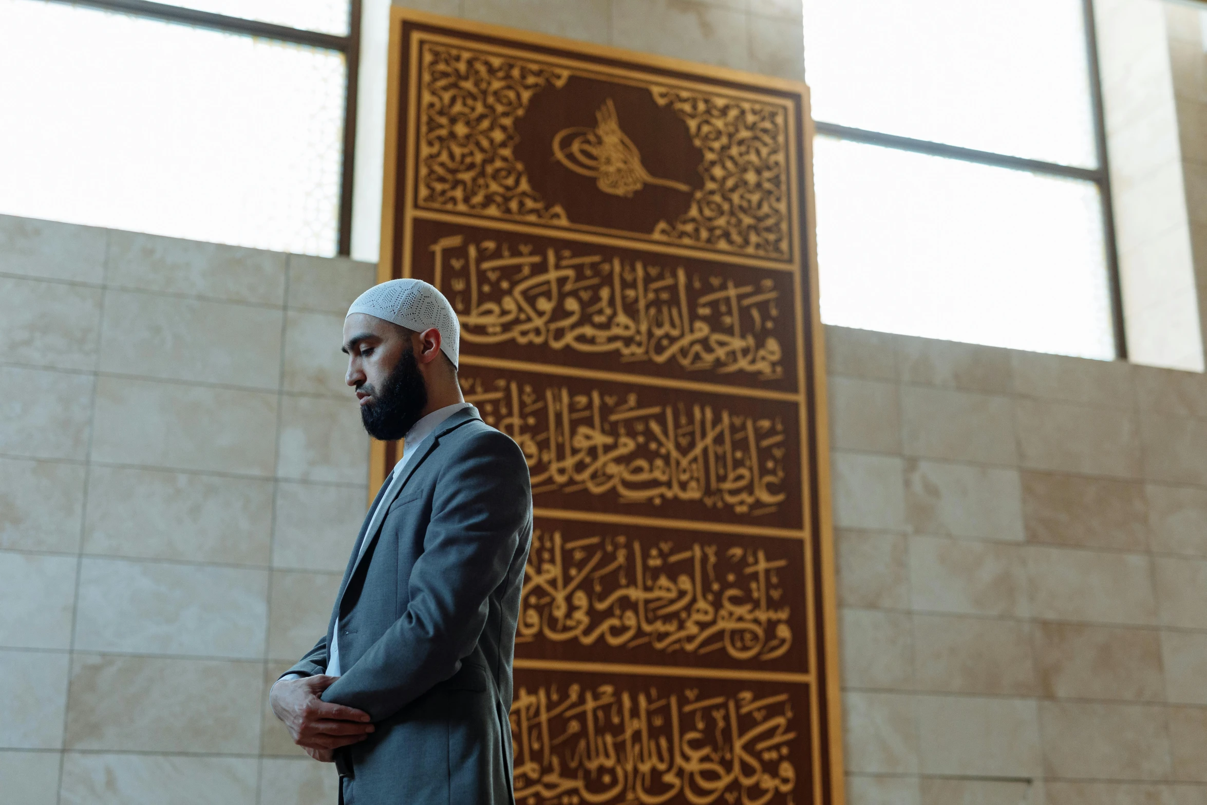 a bearded man stands in front of a sign with the word rama on it