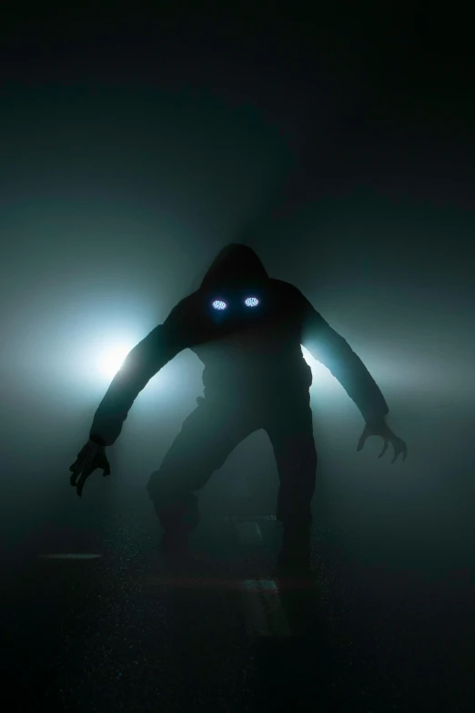 a man with two blue eyes and a hood is walking through the fog