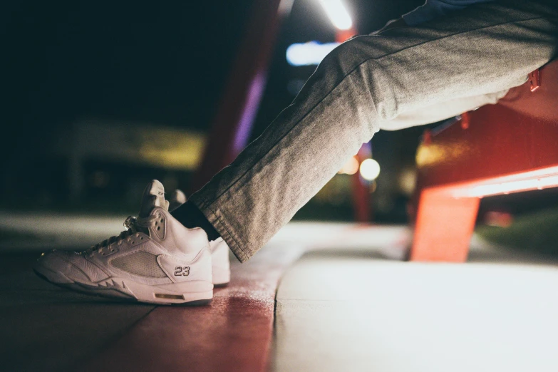 a person standing on a bench at night