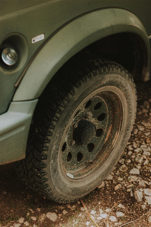 a muddy and dirty tire next to the road