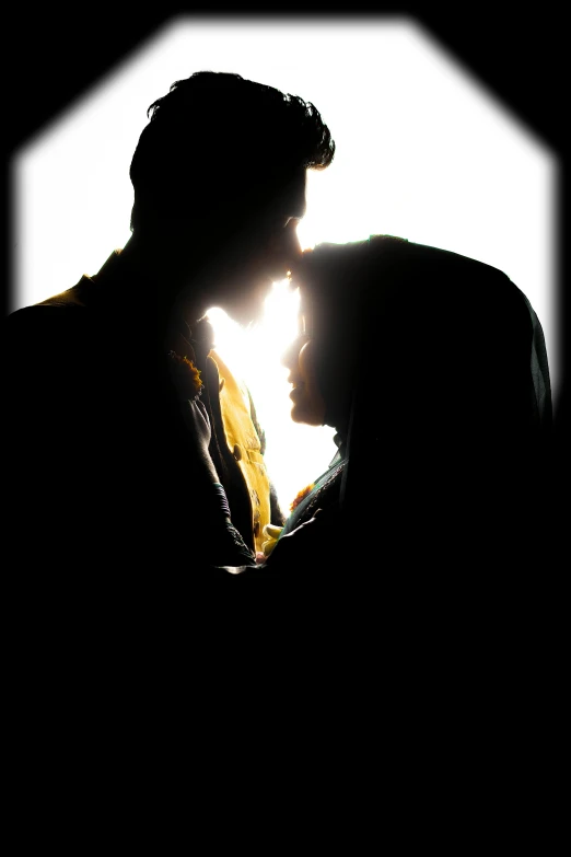 a silhouette of a kissing man and woman under an umbrella