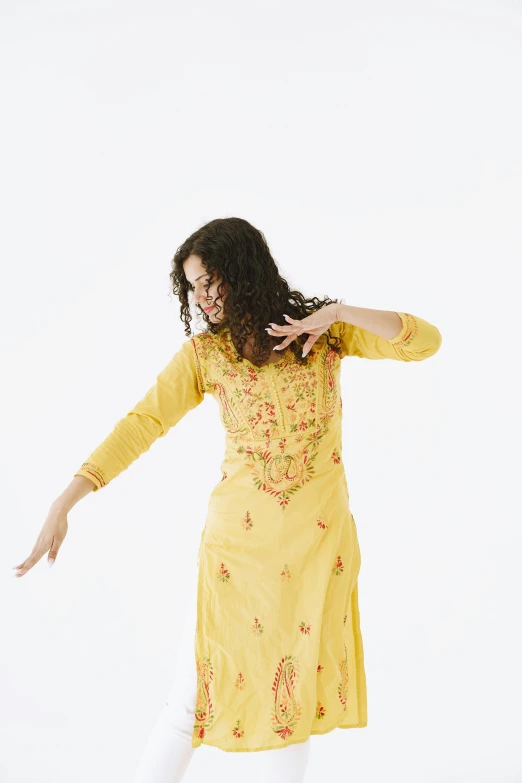 a woman in a yellow dress is posing