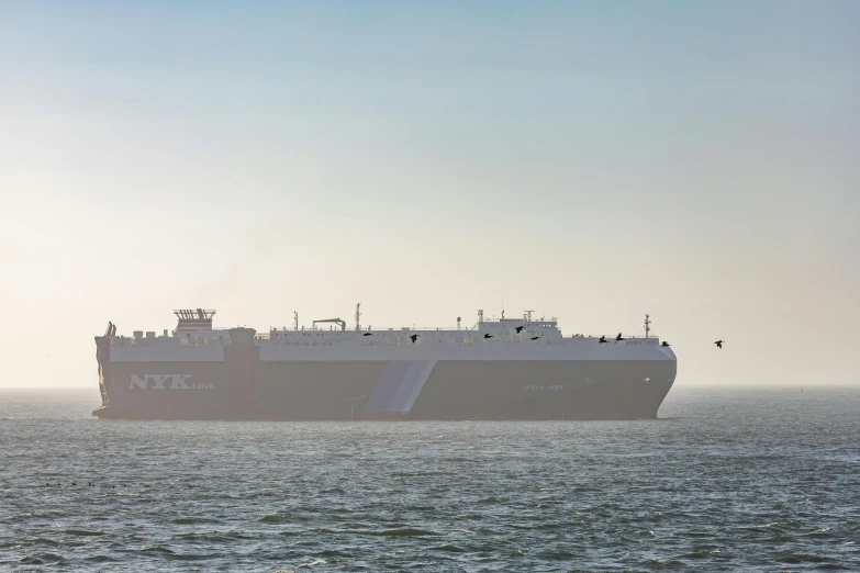 large ship floating in the open water on a foggy day