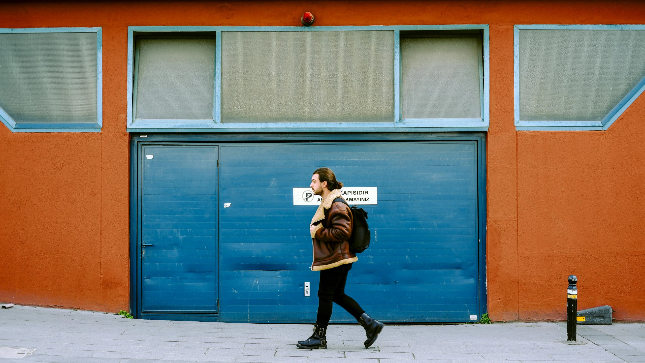 a person walking down the street carrying a sign