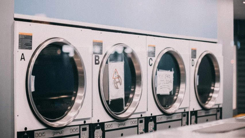 an assortment of washing machines are on display