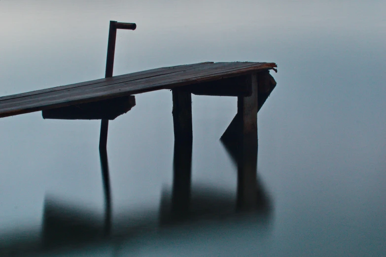 the dock is in a lake that has no one on it