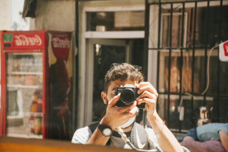 a man taking a picture of himself in front of a store