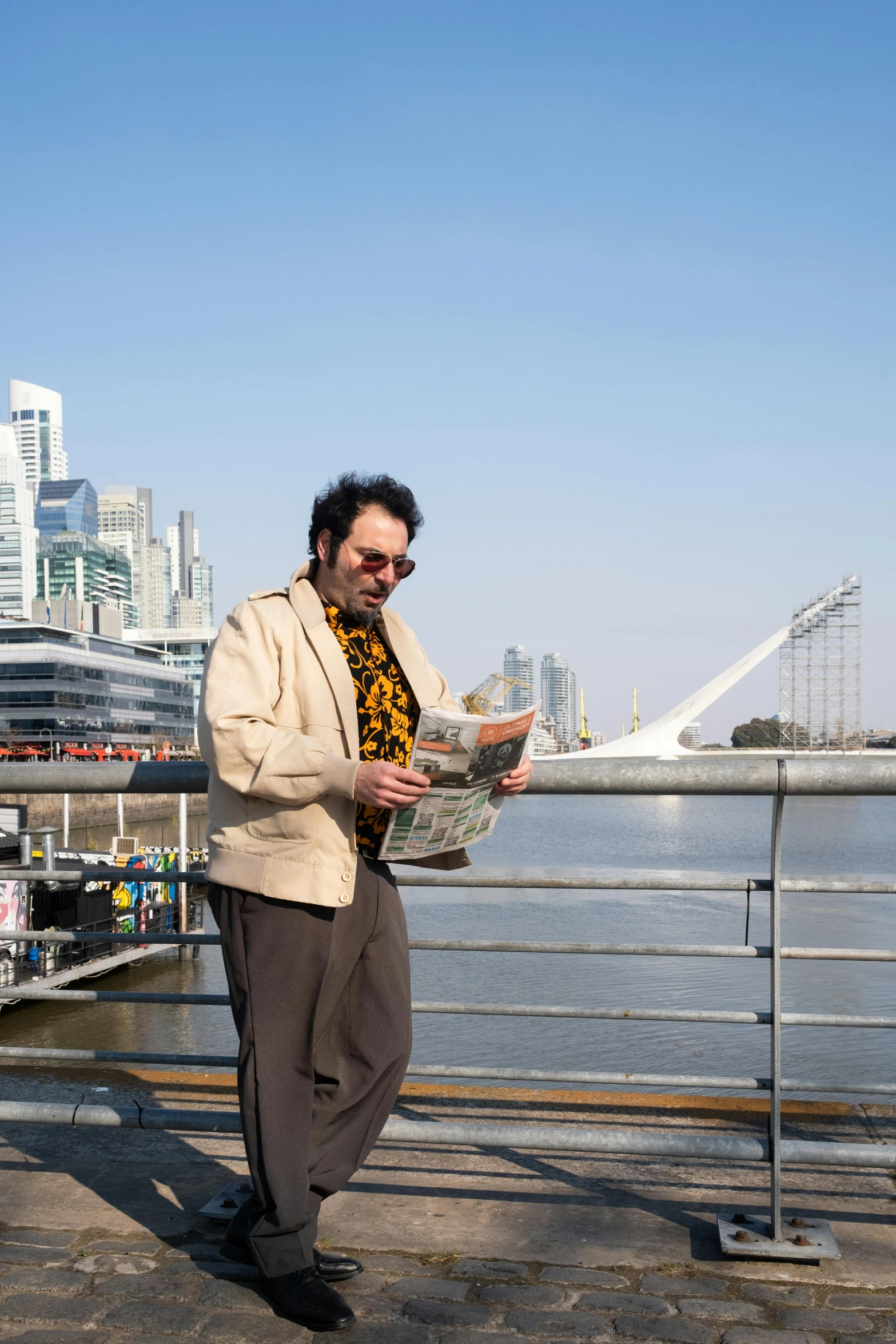 a man reading a newspaper near the ocean