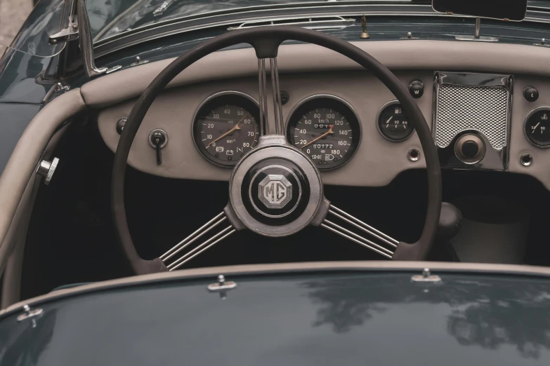 dashboard of a vintage car with several gauges and a clock on the front