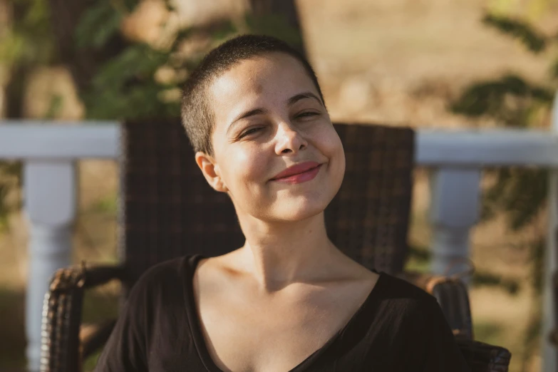 a woman sitting in a chair on a patio