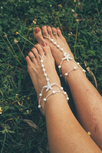 two legs wearing pearls and barefoot barefoot barefoot