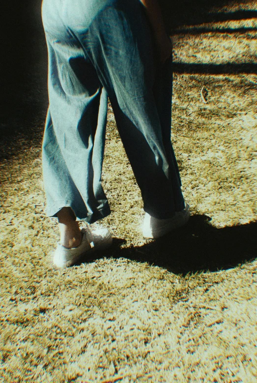 a person standing on the ground in front of a window