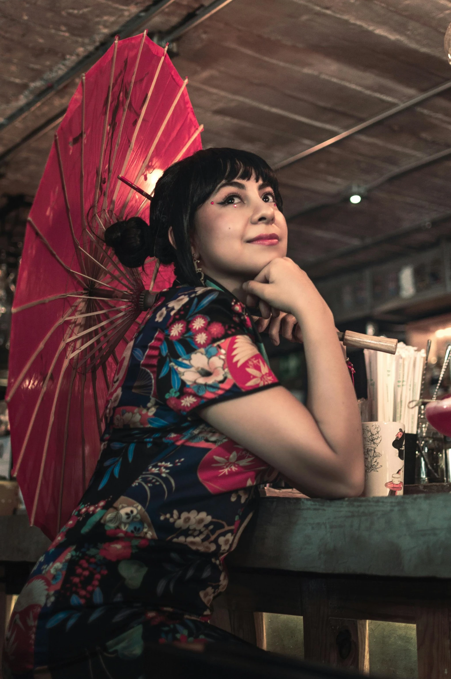 woman with a oriental dress sitting on a wooden table