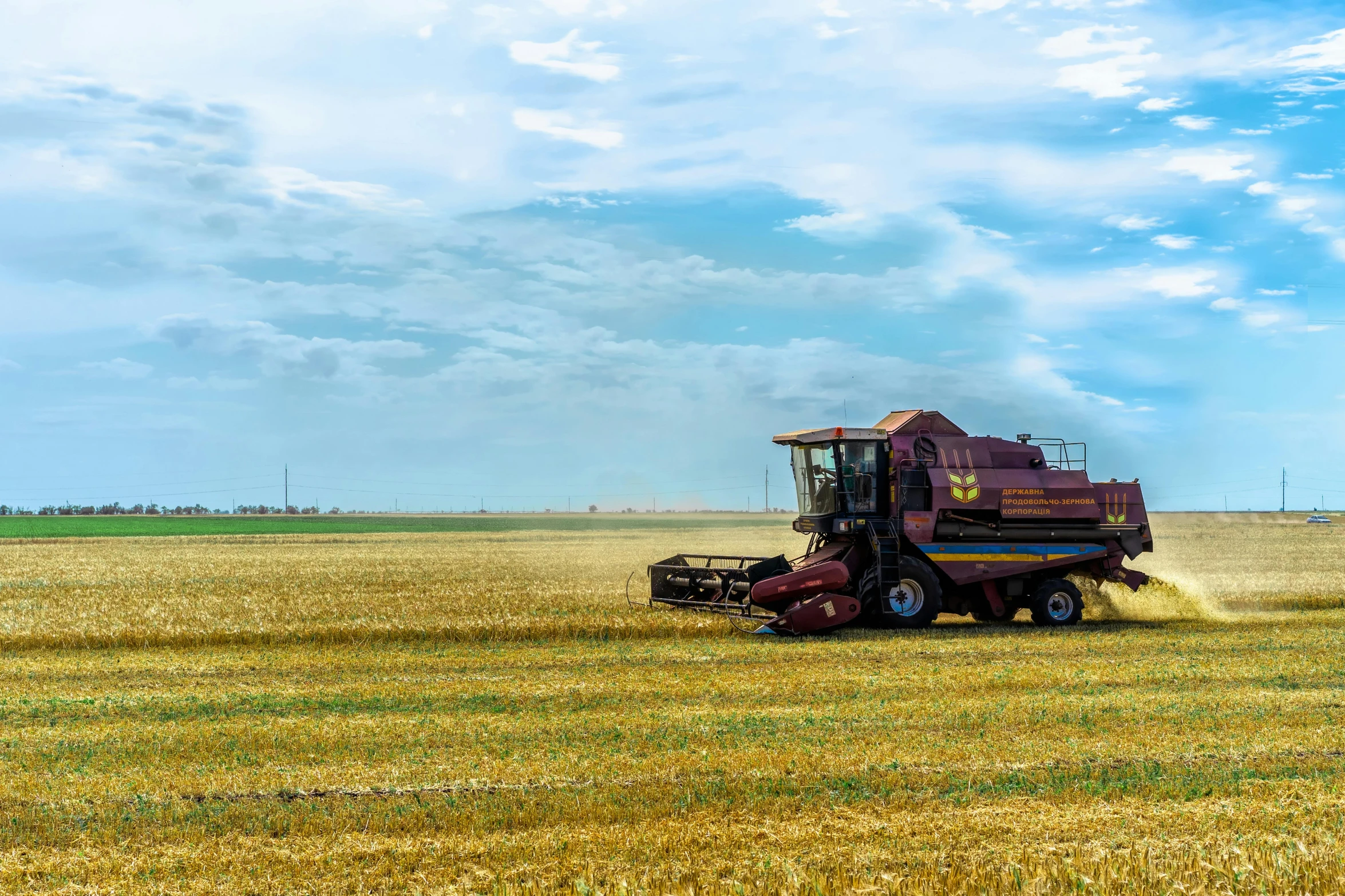 a big tractor working in the middle of a big field