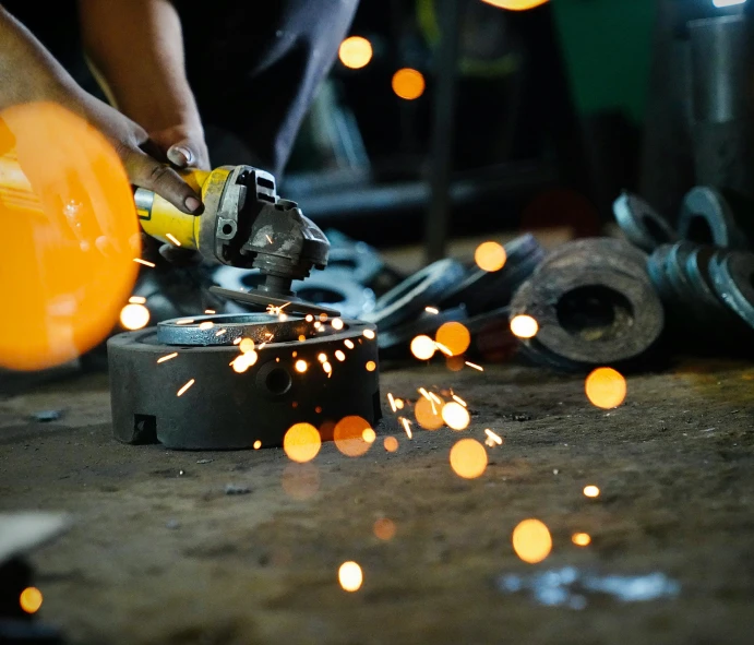 a worker in an industrial shop welding the floor