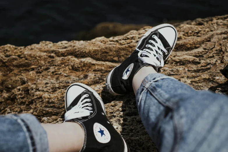 there is a pair of black shoes that are sitting on a rock