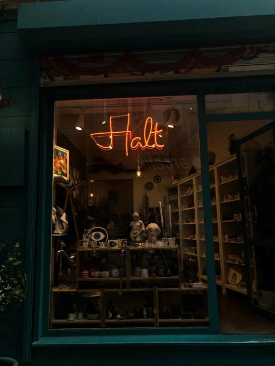 a shop window filled with objects and neon lights