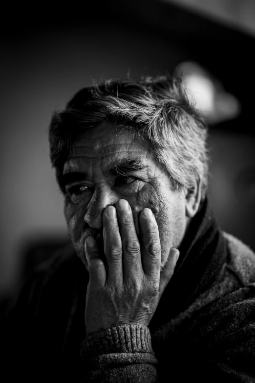 black and white pograph of a man with hand on face