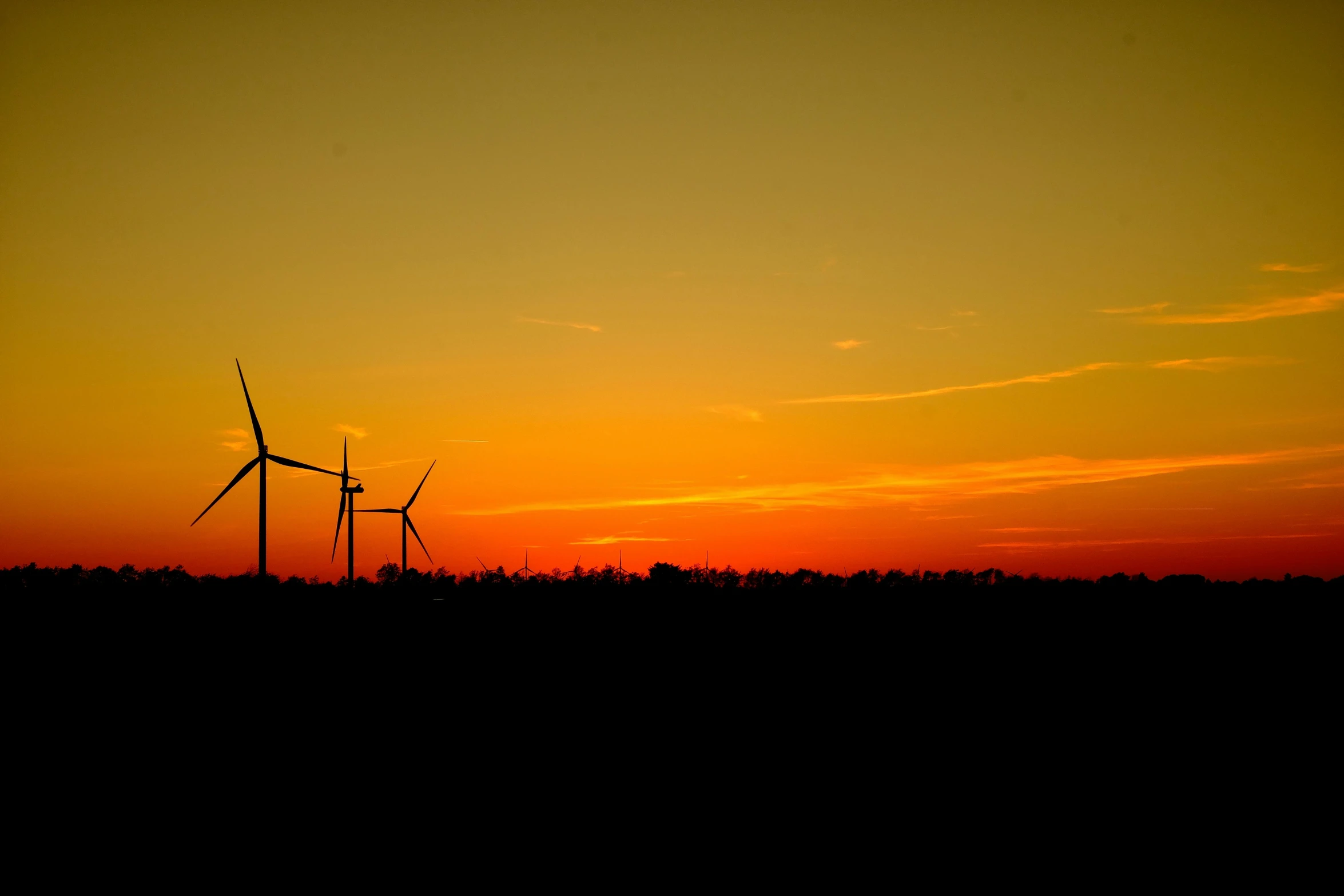 a po of windmills during a sunset