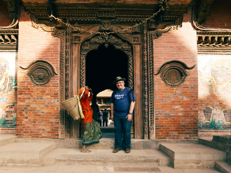 two women standing outside of an ancient building