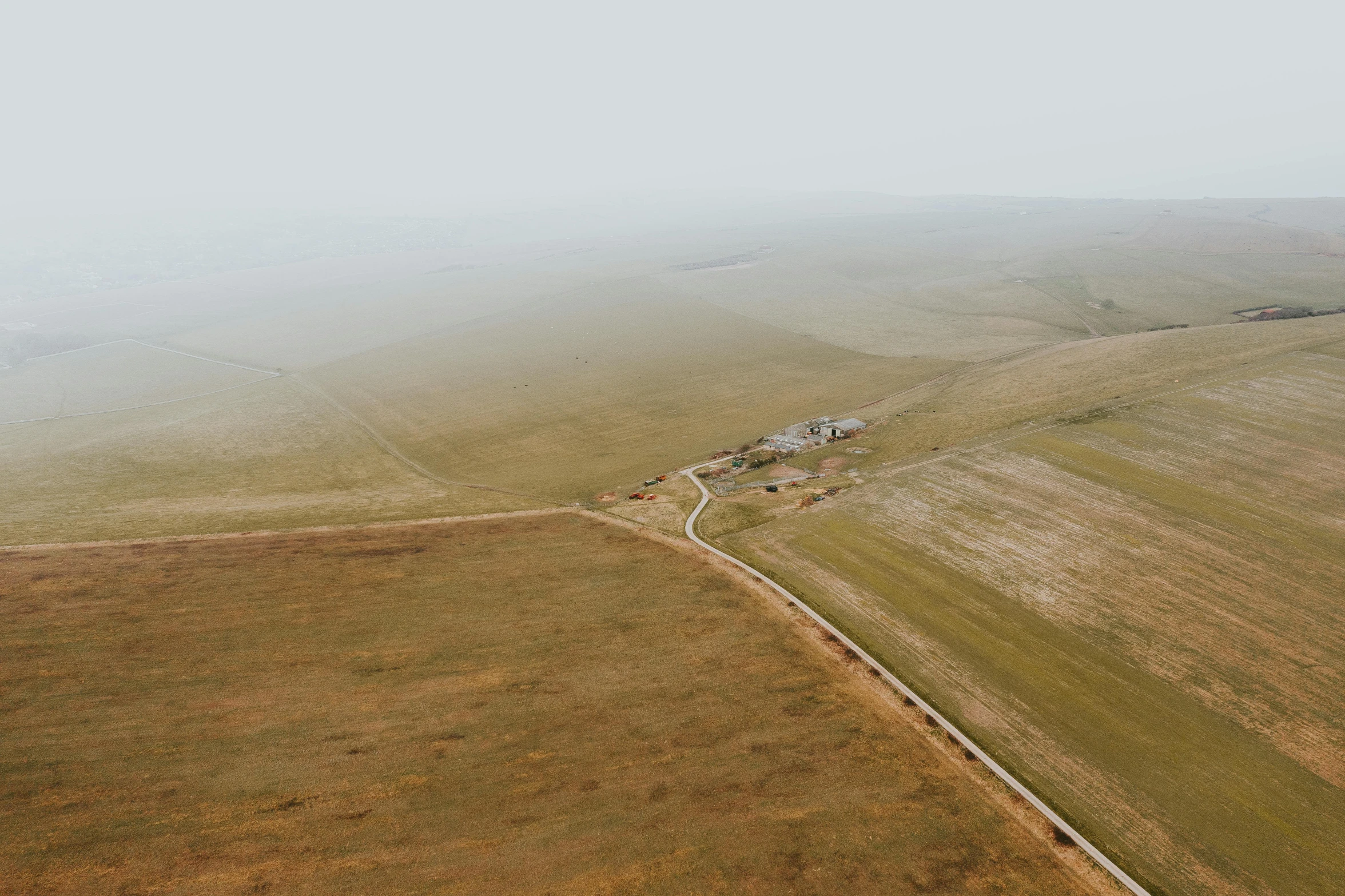 an aerial s of a large rural field in the fog