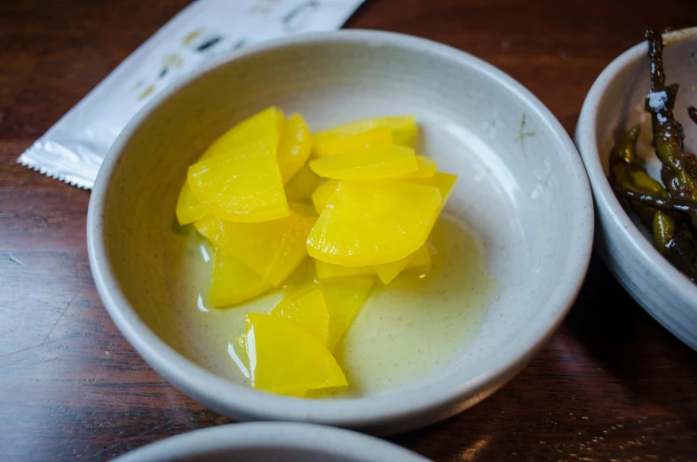 the bowl is made with mango juice and sliced in half