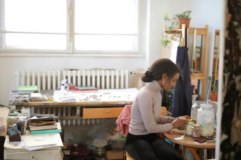 a person sitting at a desk working on soing