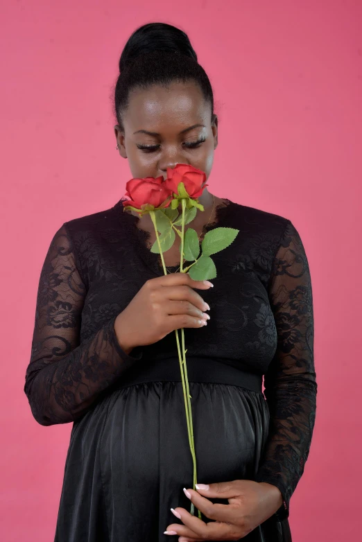 a beautiful young lady holding a flower over her face