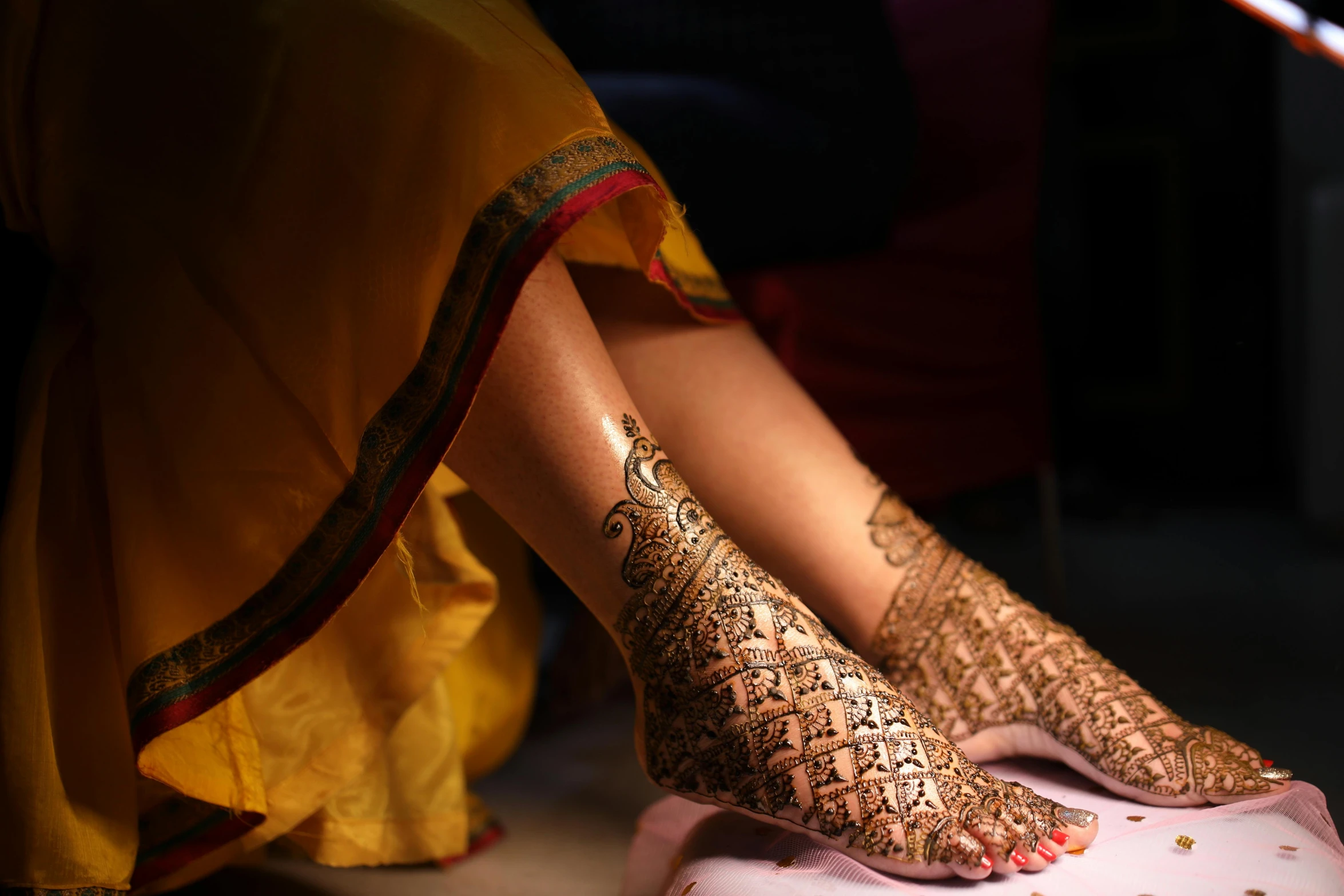 henna on feet with golden decorations on them