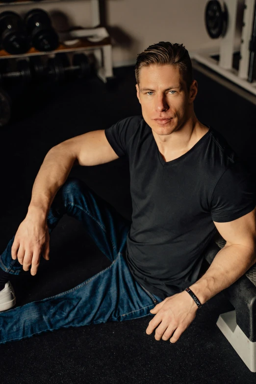 a man sitting in a gym looking at the camera