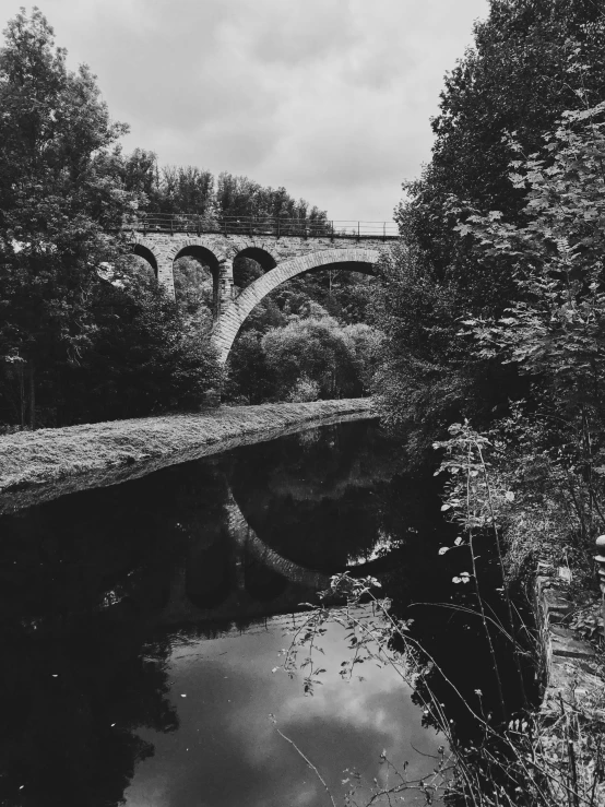 the old bridge across the water has arched arches