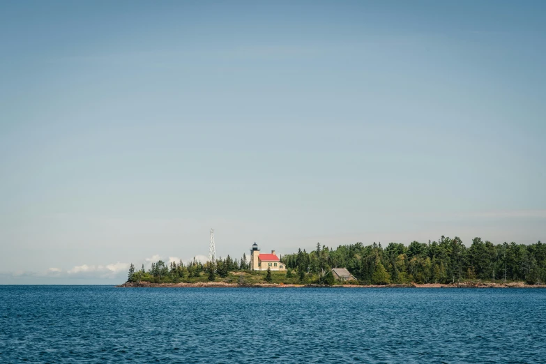 small island with light house sitting on top of it