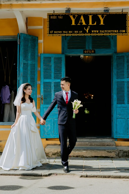 a bride and groom are running hand in hand