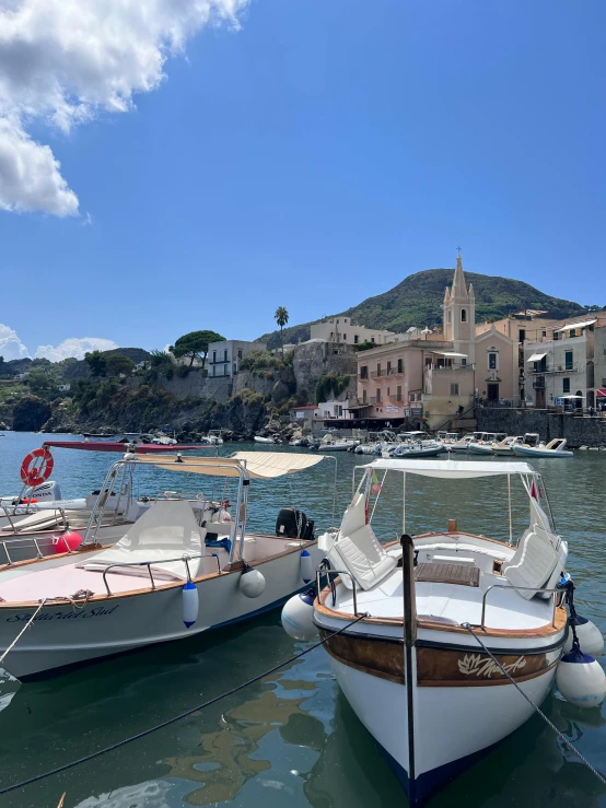 three boats docked in the bay by the town