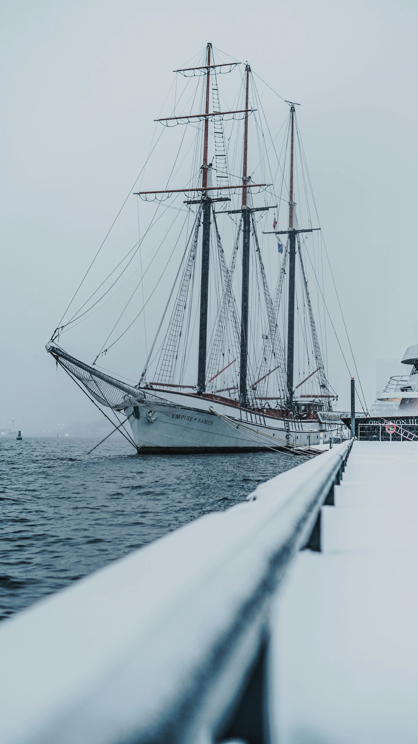 a ship in the water near a dock and a building