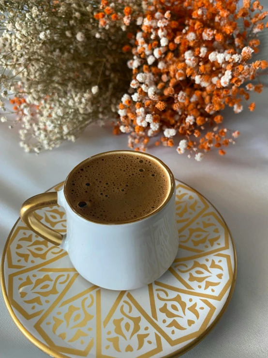 a white cup sitting on top of a saucer