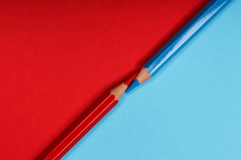 a red and blue surface with a pencil sticking out of it
