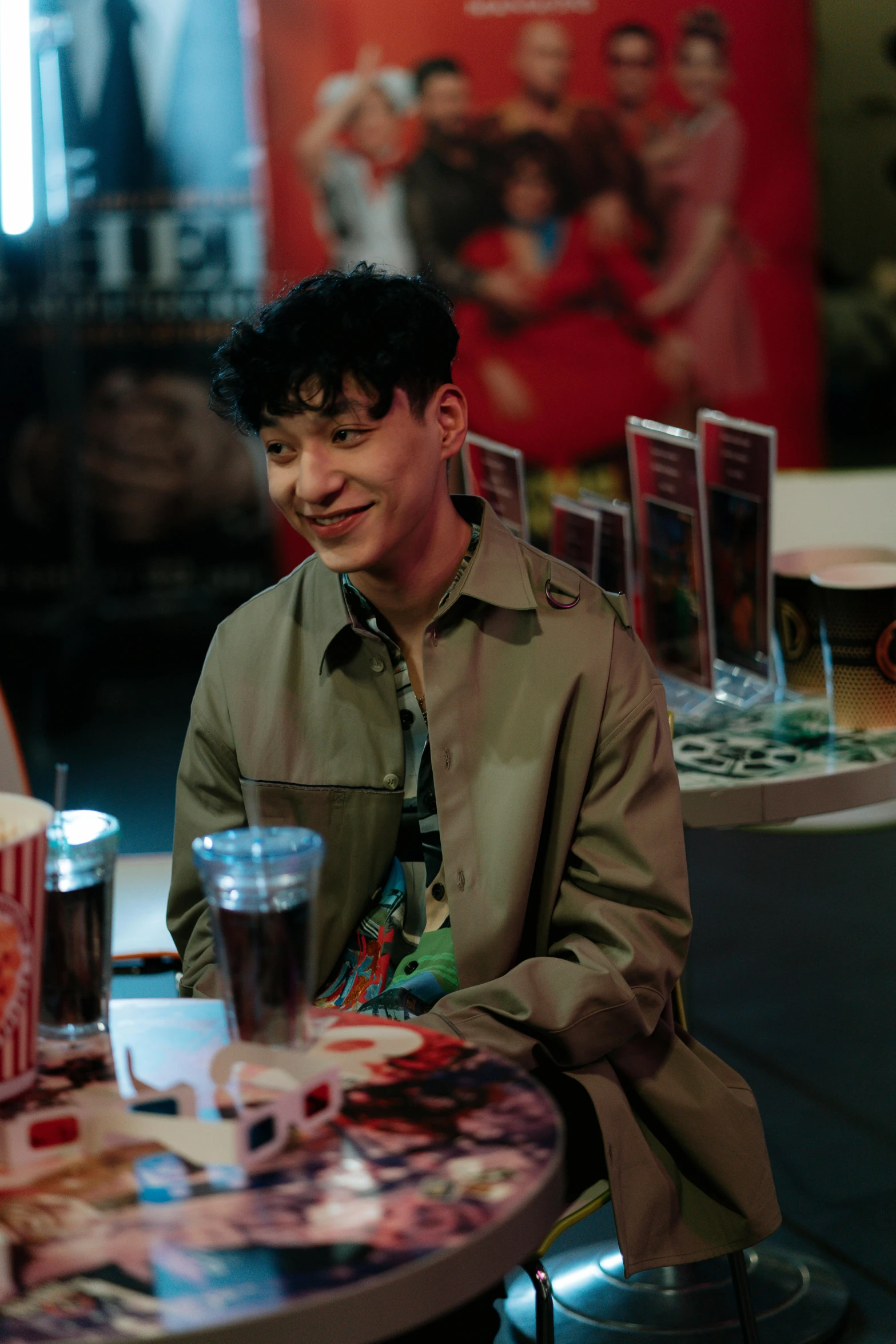 a man is sitting at a table with some cups