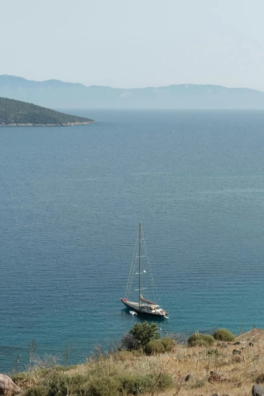 an empty boat in the water by a land line